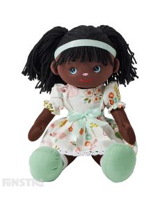 Bella is an enchanting rag doll with a soft cloth body and dark brown hair tied in pigtails and wears a whimsical dress featuring a floral and animal print and loves crafts and painting.
